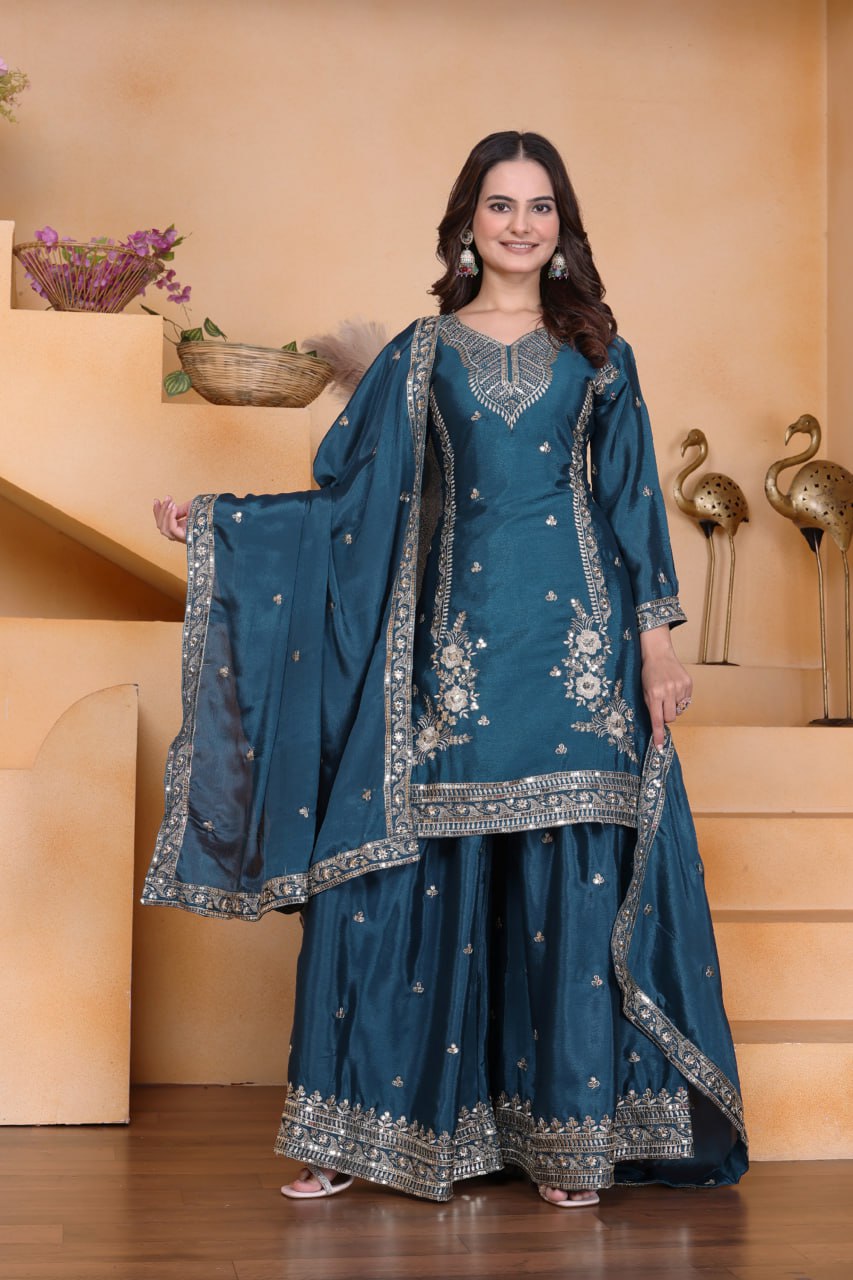 Model posing in elegant Teal Blue Chinon Sharara Set with intricate sequence embroidery