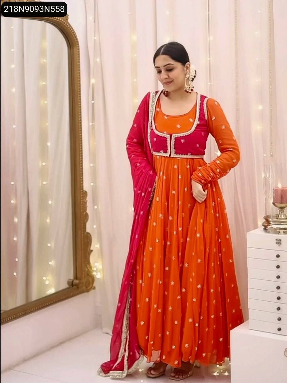 Model showcasing Orange Anarkali Gown with Red Koti and Dupatta, full pose.