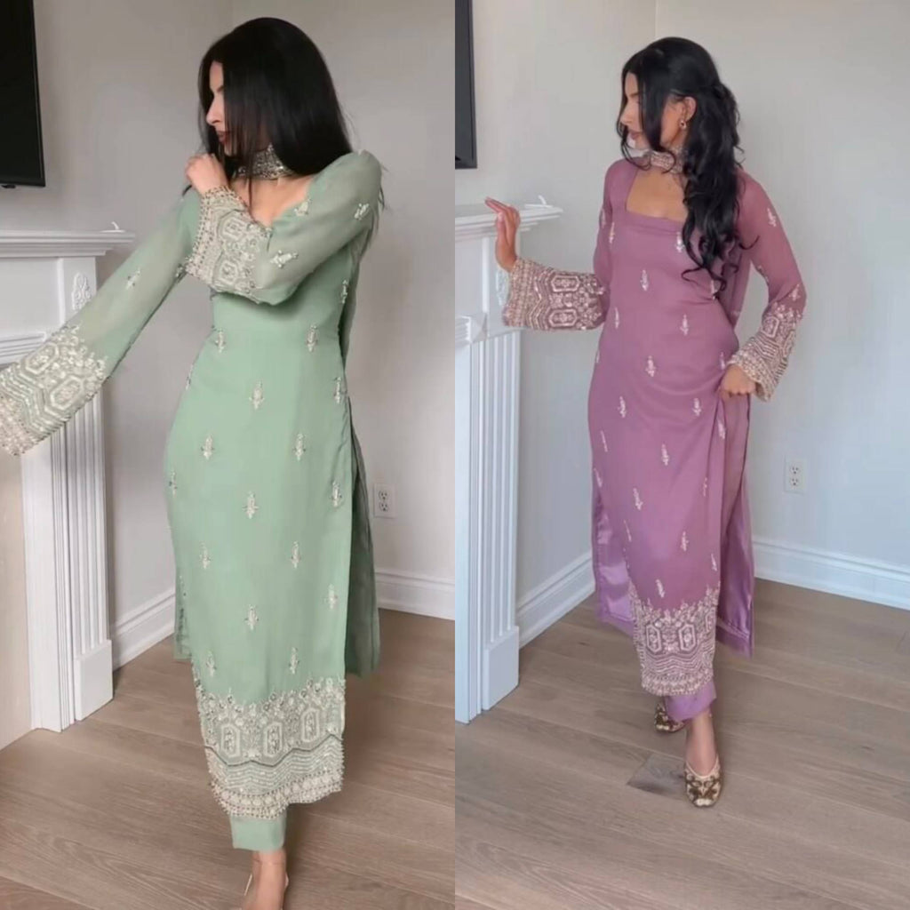 Woman posing in a mint green embroidered georgette suit set with dupatta and pants, full body shot.