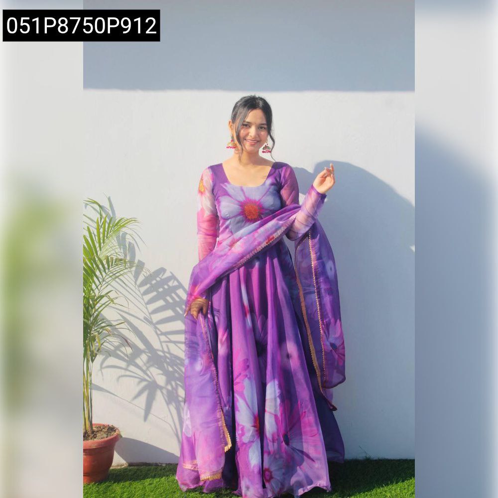 Model smiling, full body shot, wearing purple floral digital print organza gown with dupatta, standing front.