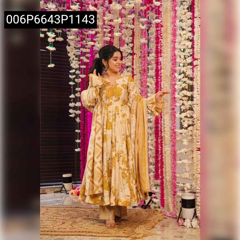 Full body shot of a model wearing the elegant light-colored Anarkali suit set with yellow floral patterns, posing against a decorative background.