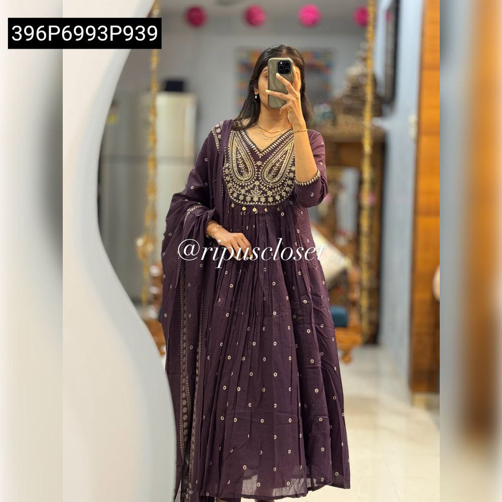 Woman posing in a dark purple embroidered cotton Anarkali suit set with a mul mul dupatta.
