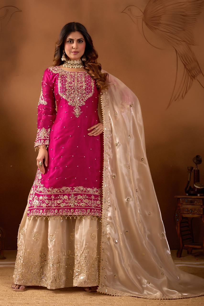 Full body shot of a model wearing a fuchsia pink embroidered Jimmy Choo silk top with a beige palazzo and matching dupatta, posing elegantly.