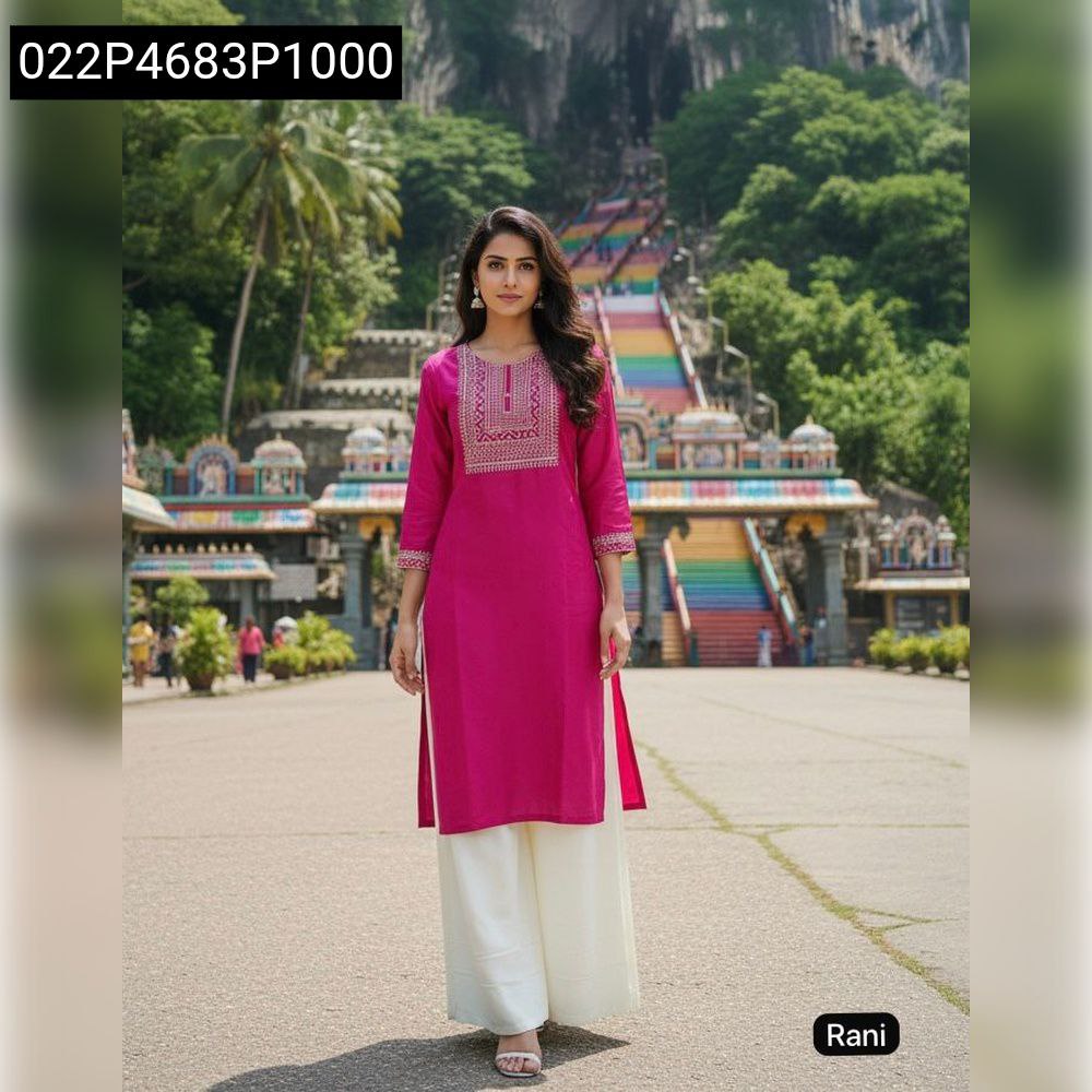 Woman posing in Rani Pink embroidered kurta and cream palazzo set, showcasing traditional Indian wear.