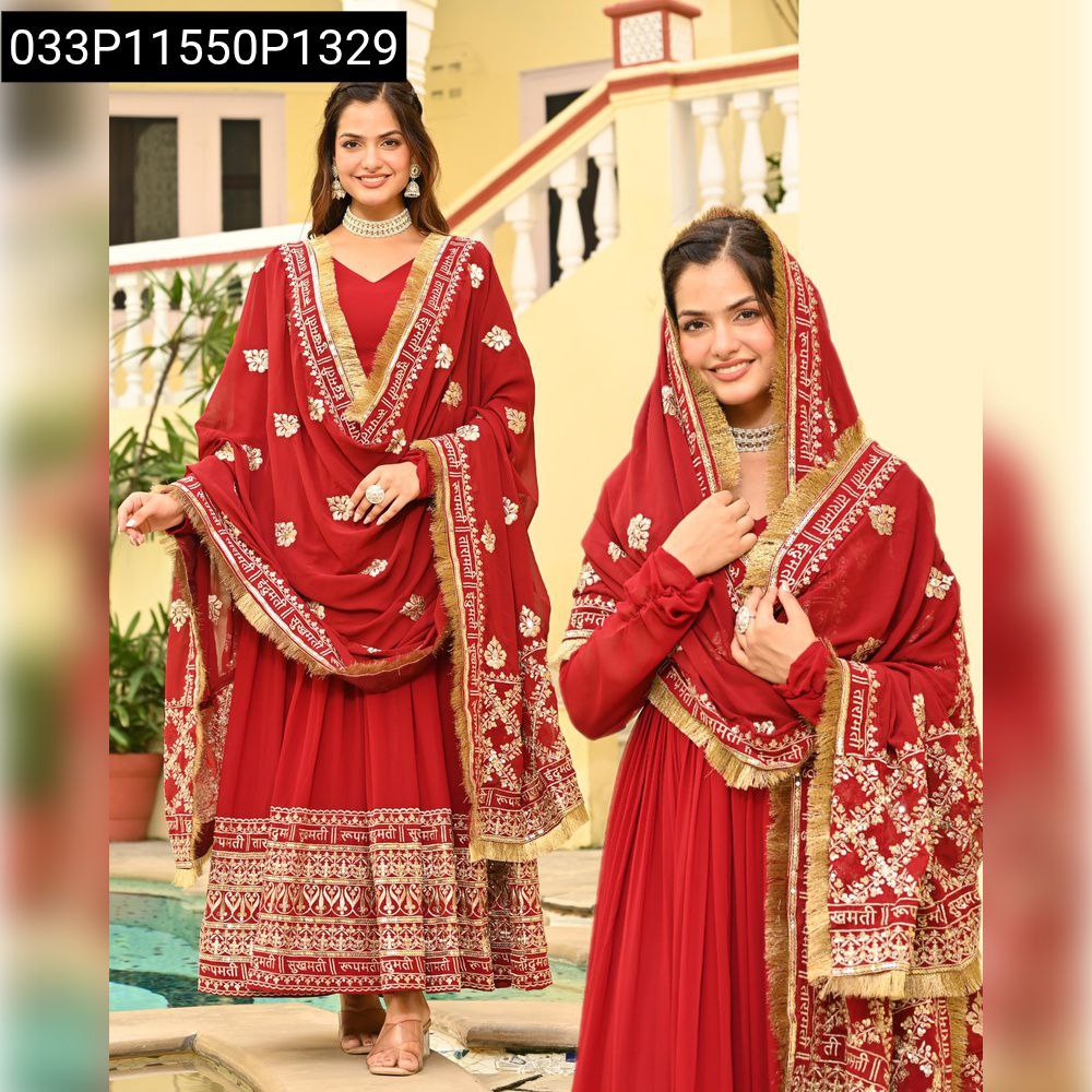 Full shot of woman in elegant red embroidered gown and matching dupatta, standing confidently by a pool.
