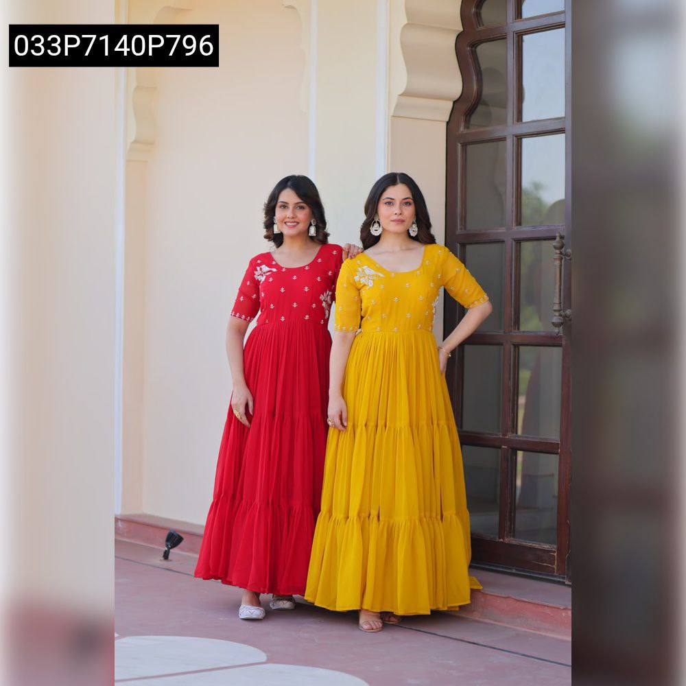 Two women in elegant red and yellow Faux Blooming gowns with bead embroidery, standing outdoors.