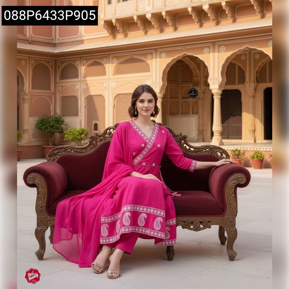 Model in hot pink cotton kurti pant dupatta set, seated elegantly in a traditional setting.