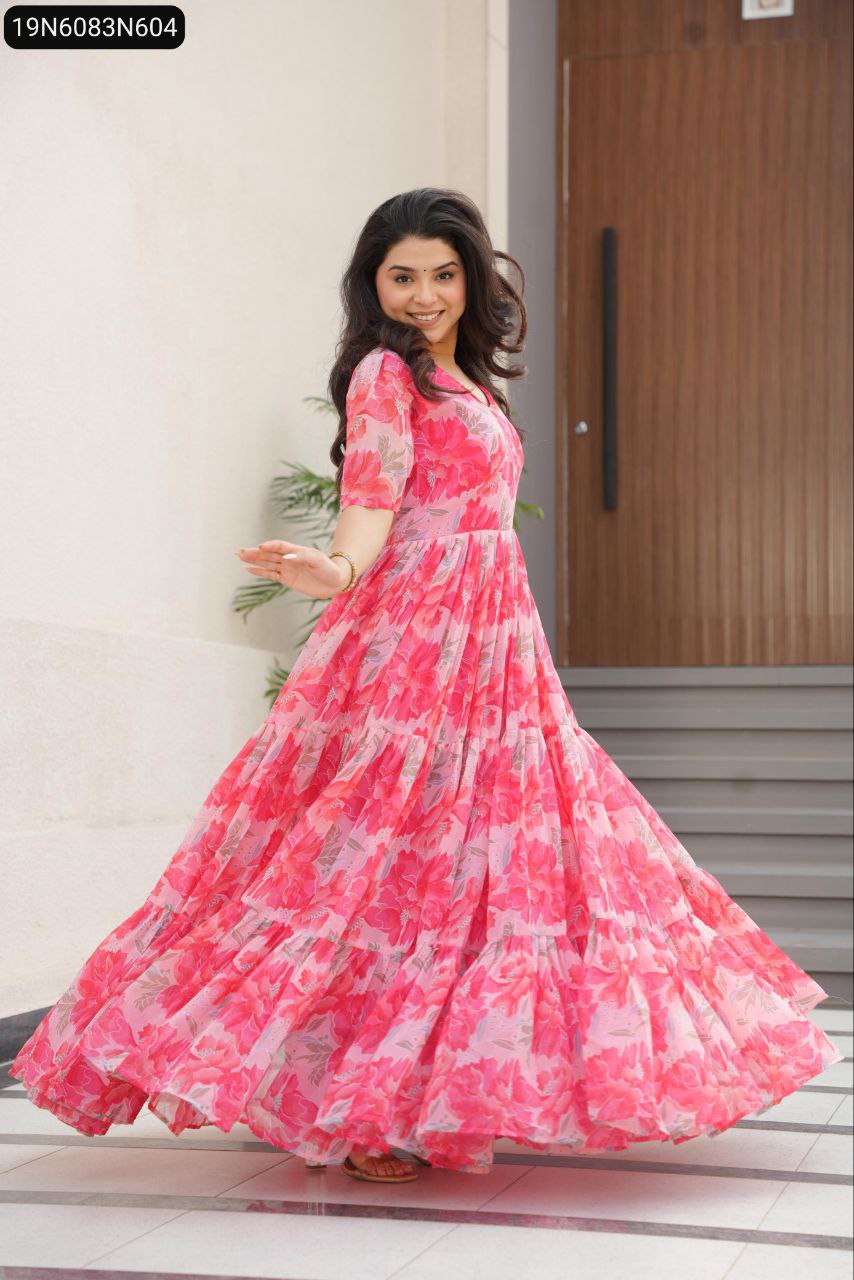 Model in a flowing peach floral faux georgette gown, smiling and twirling outdoors.