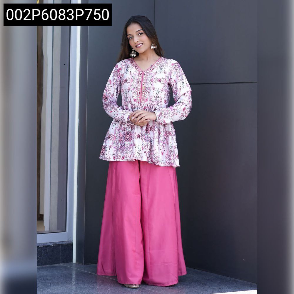 Full body shot of model wearing white floral peplum top and pink palazzo pant, traditional ethnic suit set.