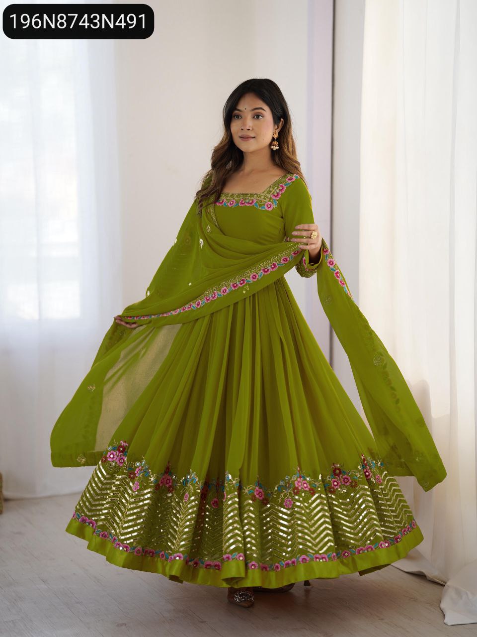 Model wearing green embroidered georgette gown with sequence work and matching dupatta.