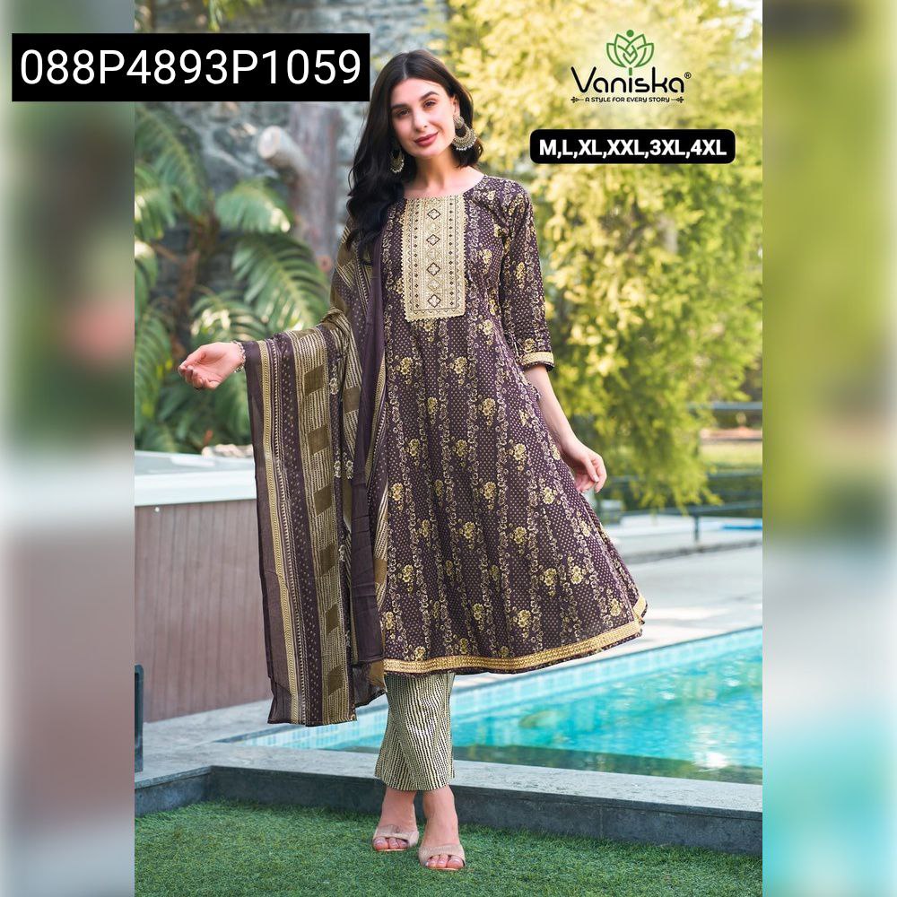 Woman posing in a Cocoa Bloom Gown Style Cotton Kurti Pant Dupatta Set, featuring gold prints and embroidery, with a matching dupatta by a poolside.