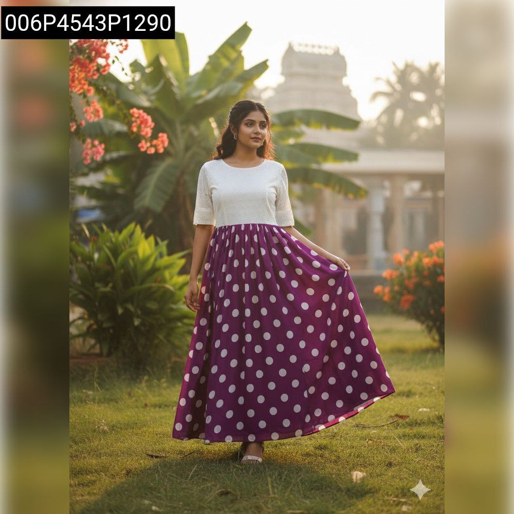 Full body shot of a woman in a white Hakoba top and purple polka dot maxi dress, standing outdoors.