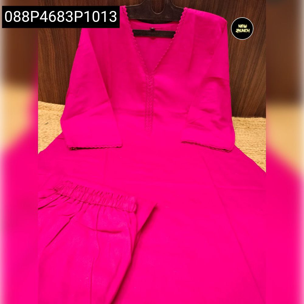 Elegant fuchsia Rayon Slub Kurti with Pant Pair, laid flat on a textured surface, showcasing the complete outfit.