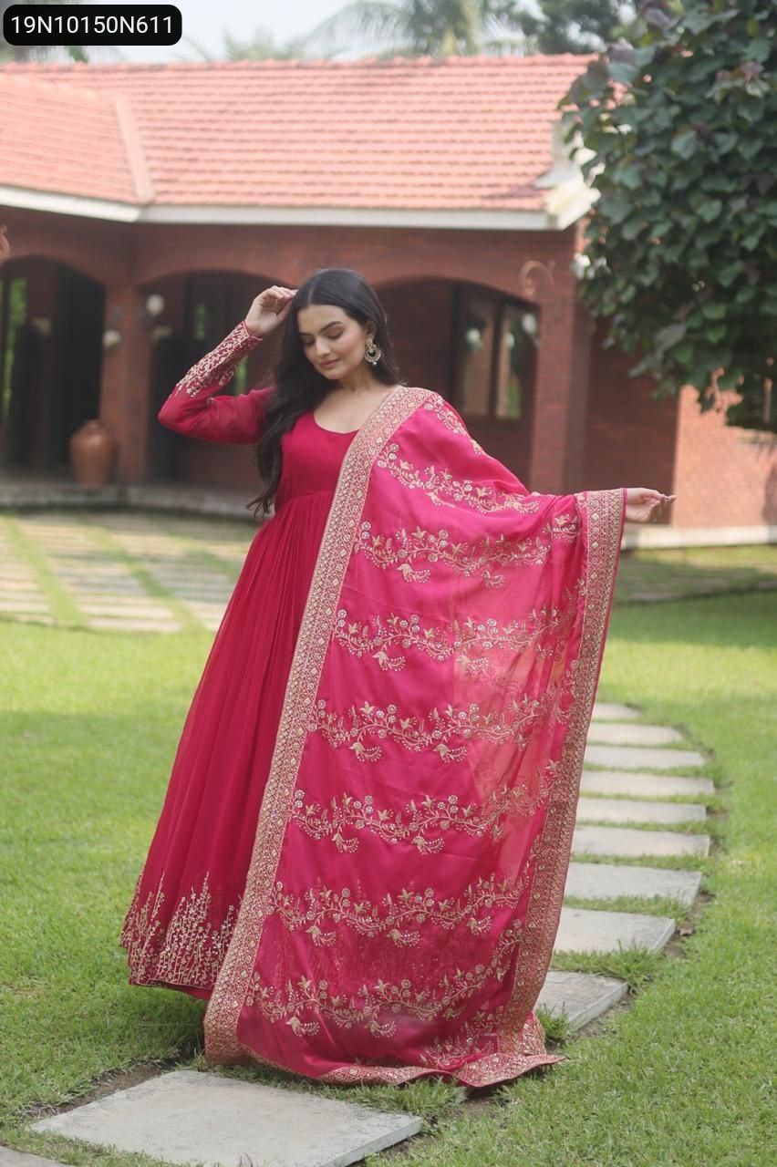 Model posing in a flowing pink Faux Blooming Anarkali gown with an embroidered dupatta, outdoors.