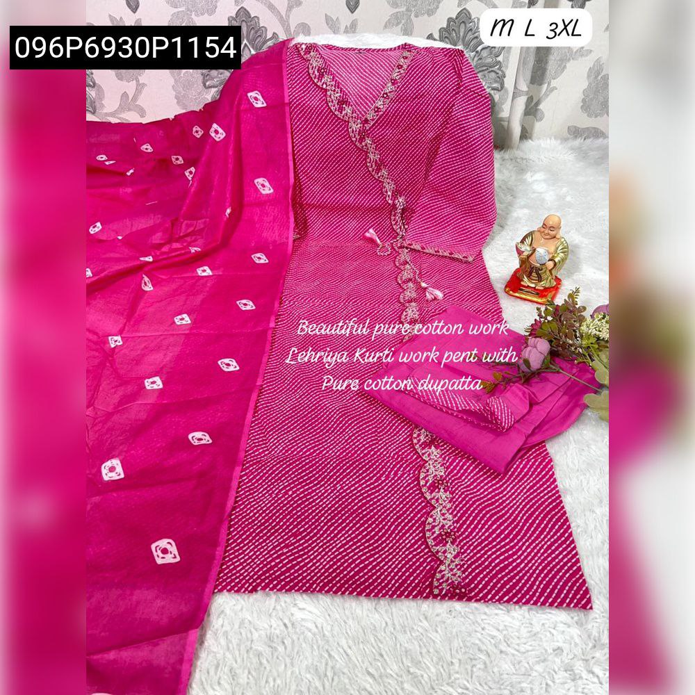 Full view of a pink Leheriya kurti pant dupatta set with intricate embroidery and tassels, displayed on a fluffy white rug next to a small golden statue.