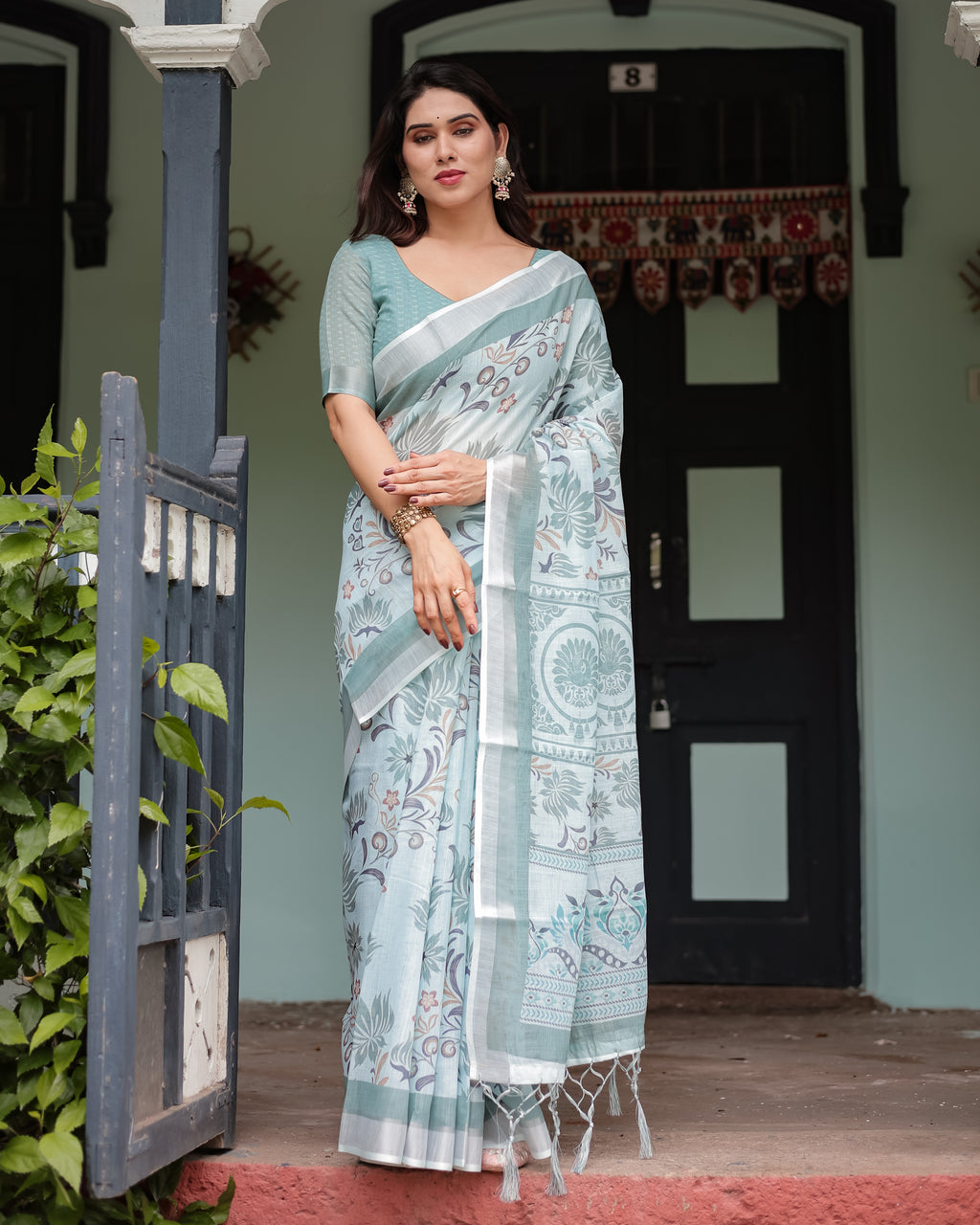 Misty Women's Green Elegance Pure Linen Saree with Tassels, full body model posing outside