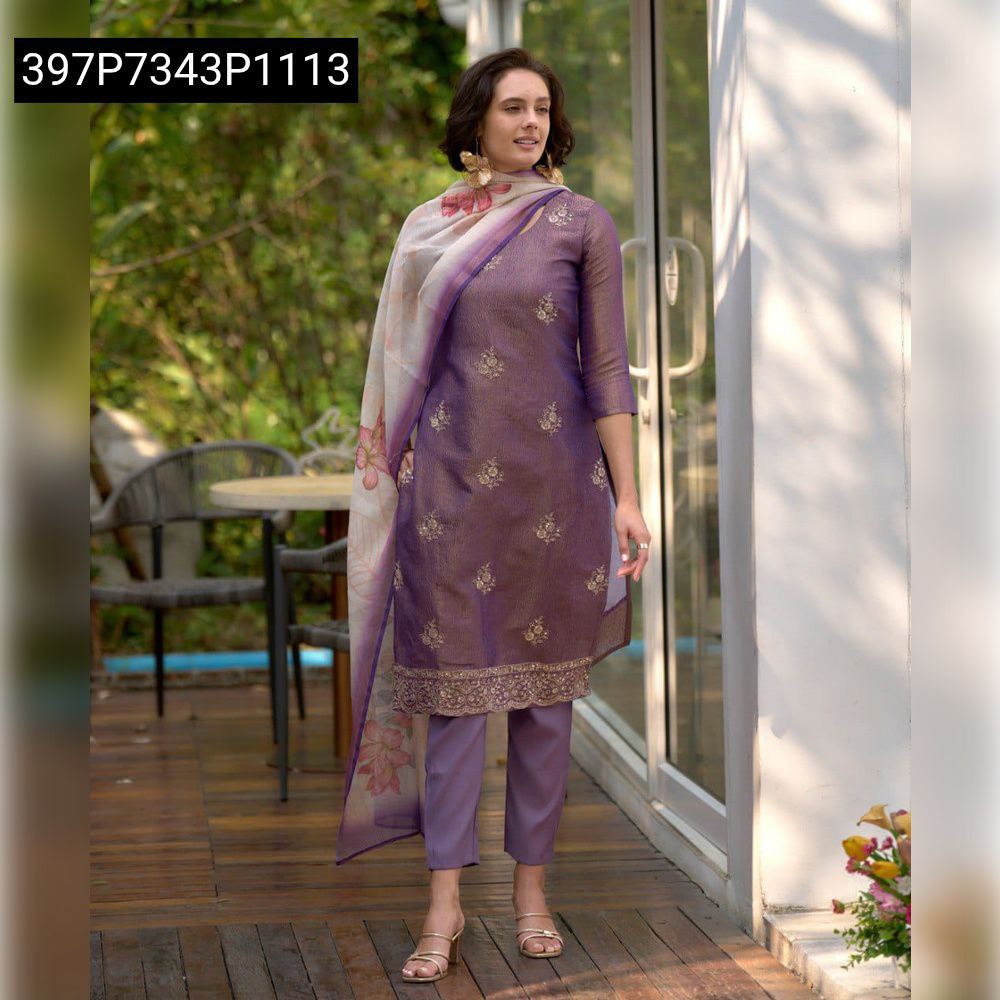 Front view of model smiling, wearing a lavender tissue silk kurta set with floral embroidery and embellished dupatta.