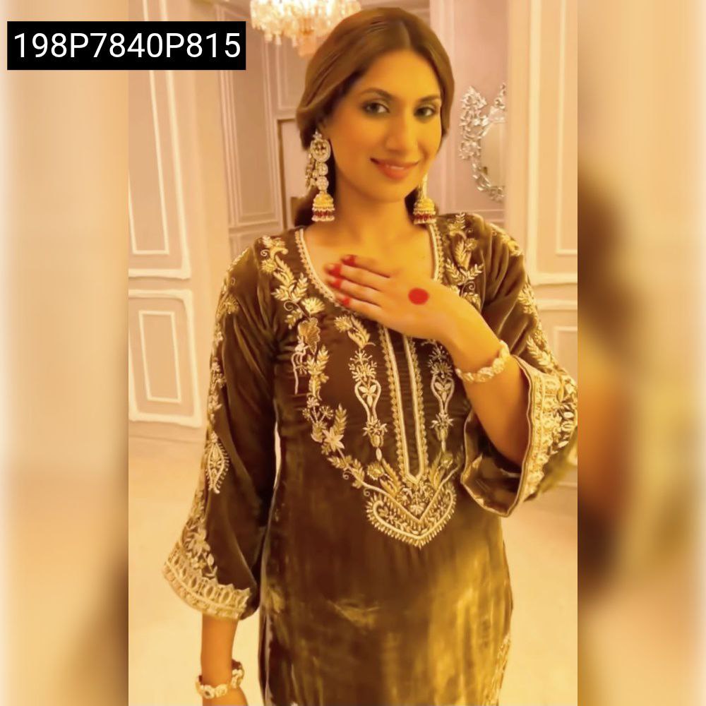 Elegant woman in olive gold velvet kurti set with embroidery, posing for a fashionable look.