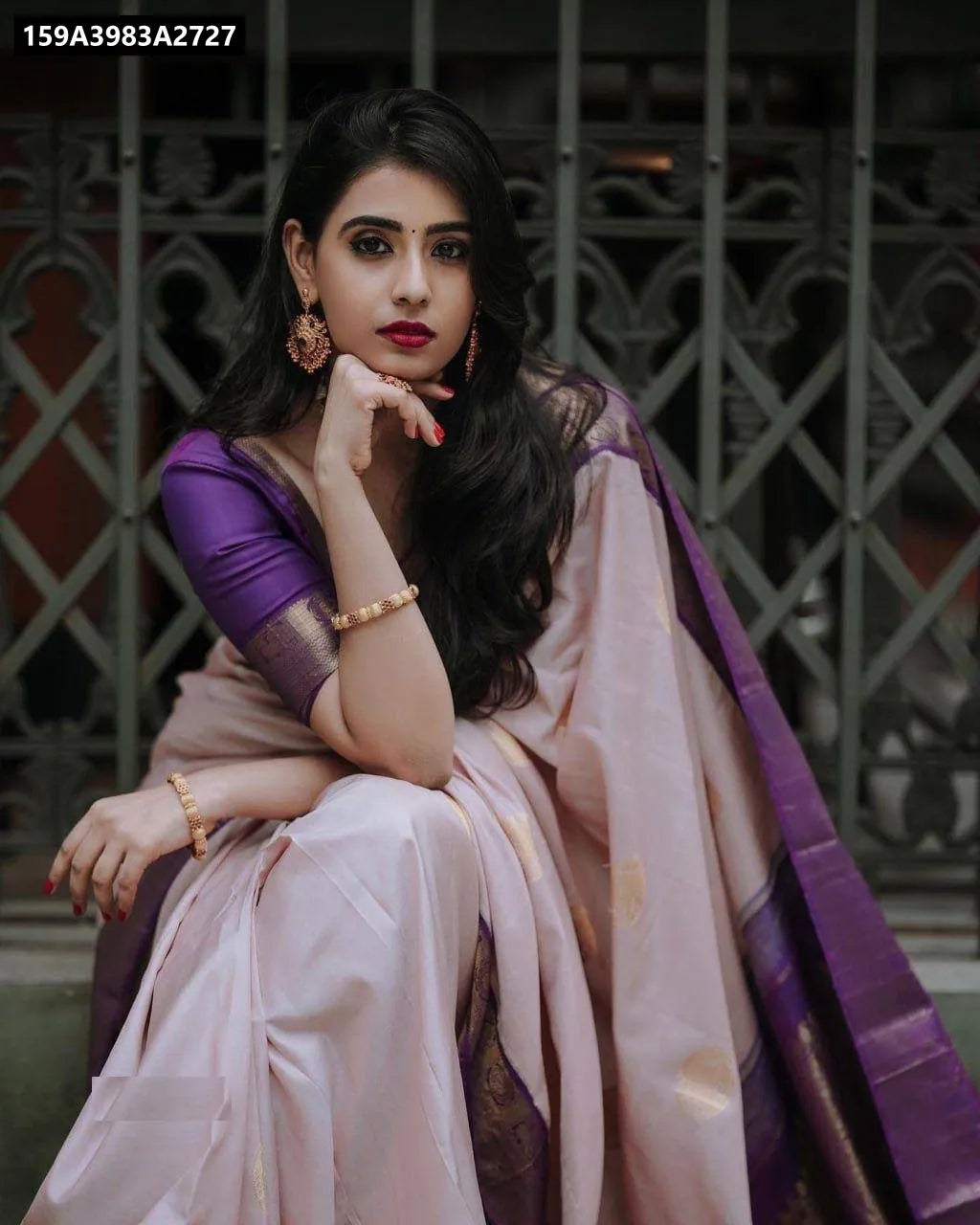 Woman in beige and lavender Lichi Silk Saree, front pose, showcasing elegant drape and border.
