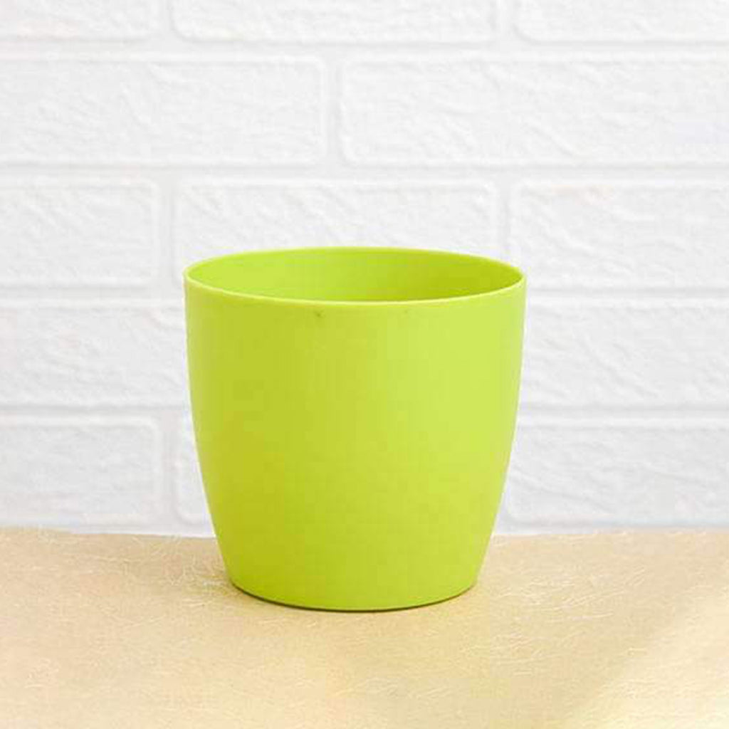 Close-up of the transparent water level indicator on a vibrant green plastic planter
