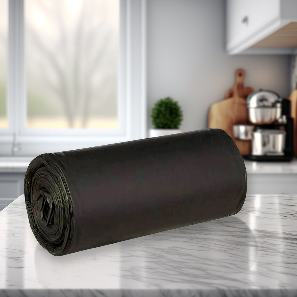 Close-up of a roll of black trash liners showing the perforated tear-off line